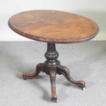 A Victorian burr walnut occasional table, with a hinged oval top, on a splayed base 106w x 73cm