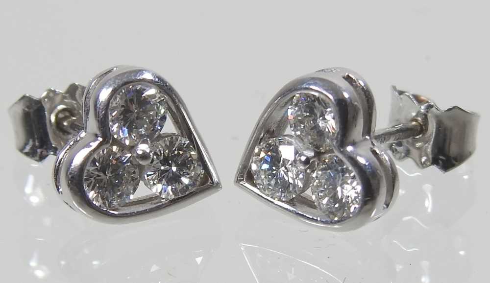 A pair of 18 carat white gold and diamond heart shaped earrings, each set with three, 1.9g, - Image 3 of 4