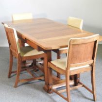 A 1930's light oak draw leaf dining table, together with a set of four matching dining chairs (5)