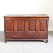 An 18th century oak dowry chest, with a hinged lid and drawers below 141w x 47d x 84h cm
