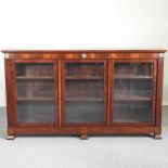An early 20th century glazed mahogany dwarf bookcase, with gilt metal mounts, enclosed by glazed