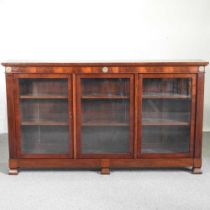 An early 20th century glazed mahogany dwarf bookcase, with gilt metal mounts, enclosed by glazed