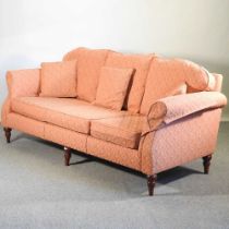 A modern peach upholstered sofa, recently re-upholstered, on turned feet 220w x 90d x 85h cm