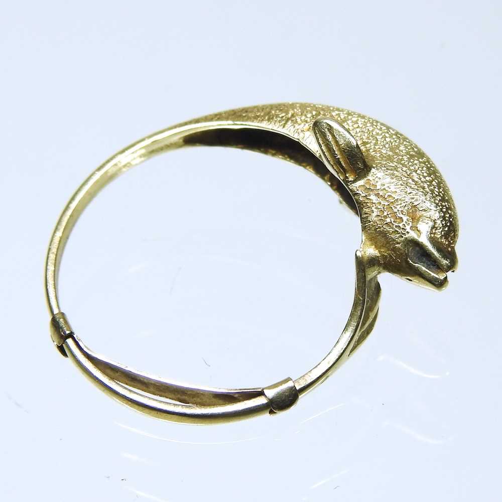A 14 carat gold ring, in the form of a dolphin, 2.8g, size P, boxed