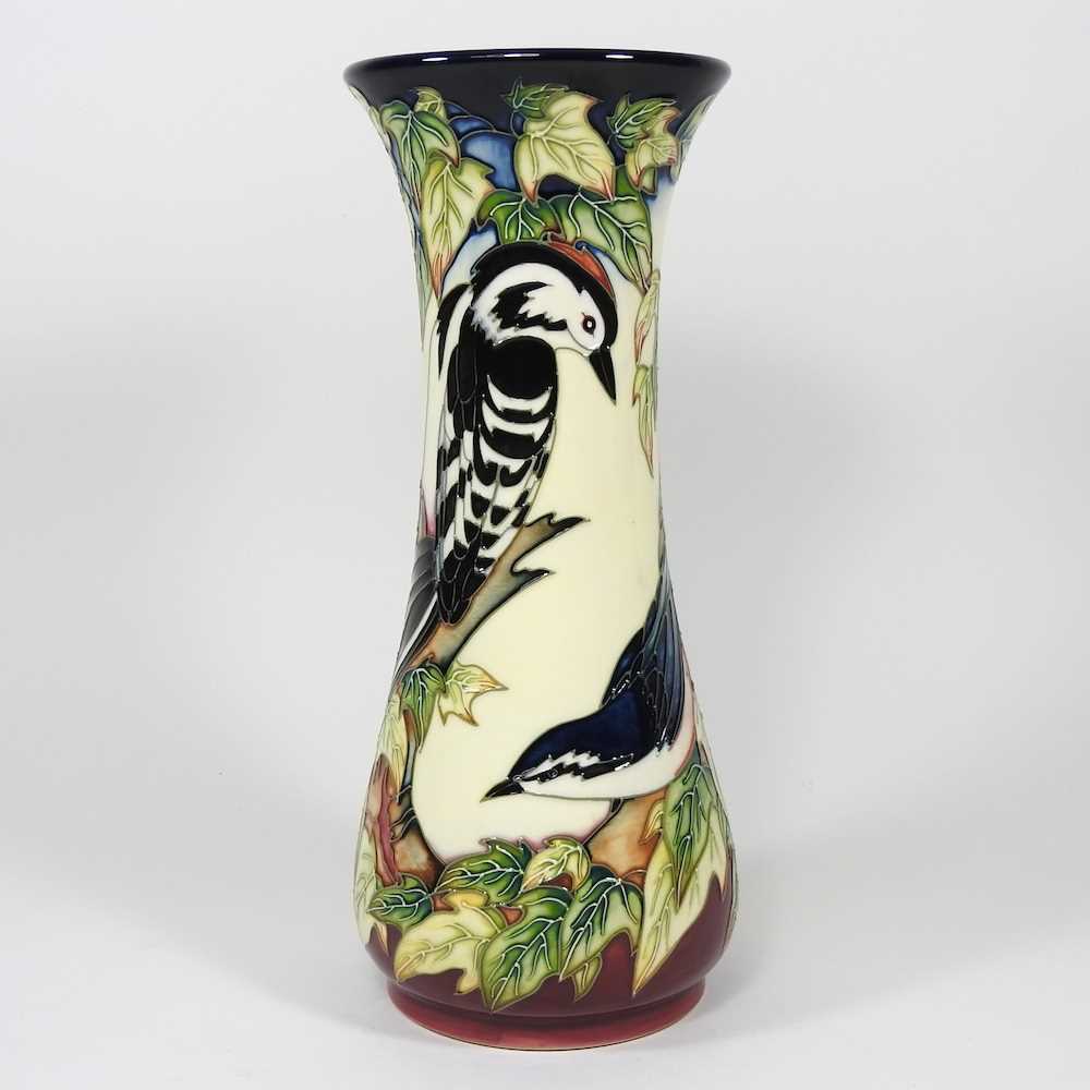 A Moorcroft pottery vase, of waisted form, decorated in the Inglewood pattern, with a woodpecker and