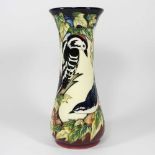 A Moorcroft pottery vase, of waisted form, decorated in the Inglewood pattern, with a woodpecker and