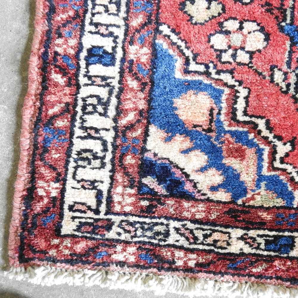 A Persian Sarouk runner, with foliate designs, on a red ground, 330 x 80cm - Image 3 of 3