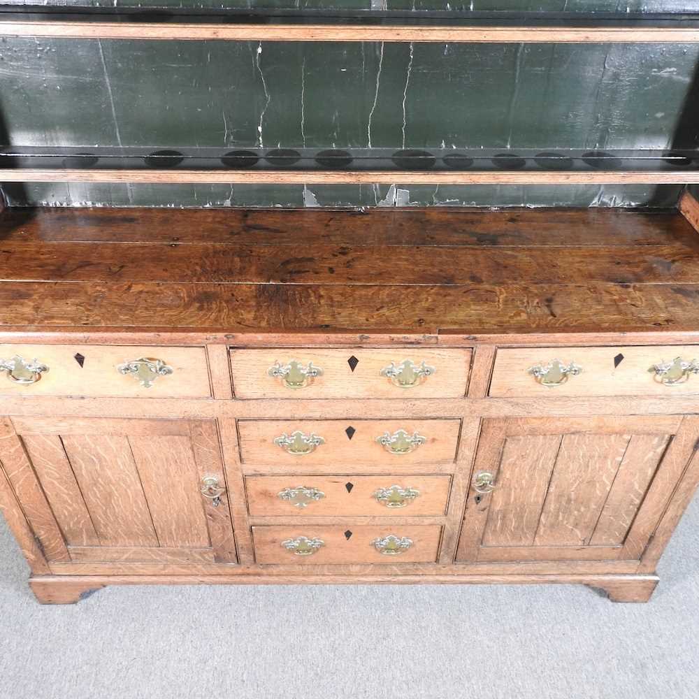 An 18th century Welsh oak dresser, having a boarded back, over an arrangement of short drawers and - Image 3 of 7