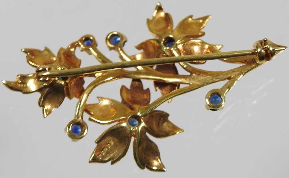 A 9 carat gold and sapphire brooch, in the form of a floral spray, 7.1g, 45mm wide, cased - Image 3 of 5