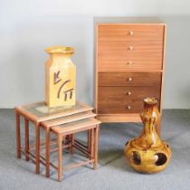 A 1970's chest, 61cm wide, together with a nest of three oak tile top occasional tables and two