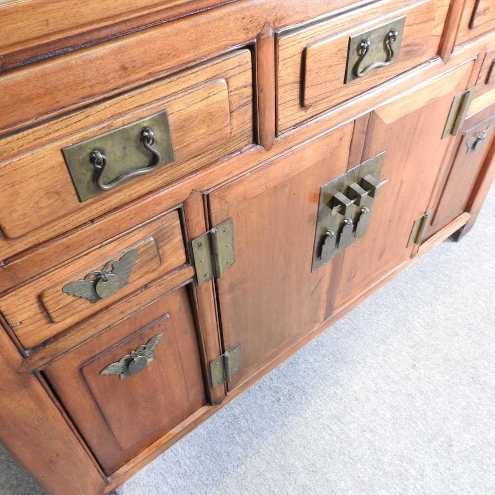 A modern Chinese hardwood sideboard, containing short drawers and cupboards 126w x 50d x 88h cm - Image 3 of 7