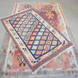 A kelim rug, with three rows of coloured diamonds, 240 x 146cm, together with another smaller, (2)