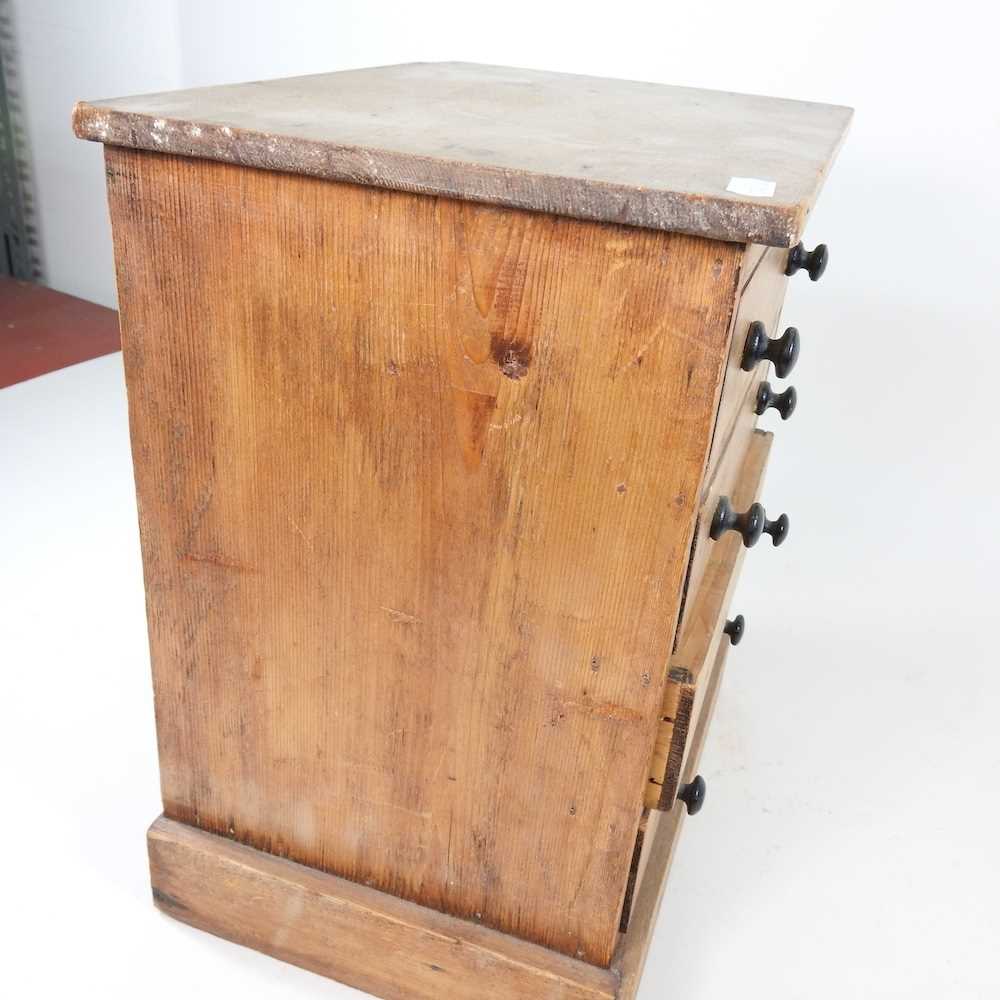 A Victorian pine miniature chest, containing four long drawers, on a plinth base 29w x 22d x 35h cm - Image 2 of 7