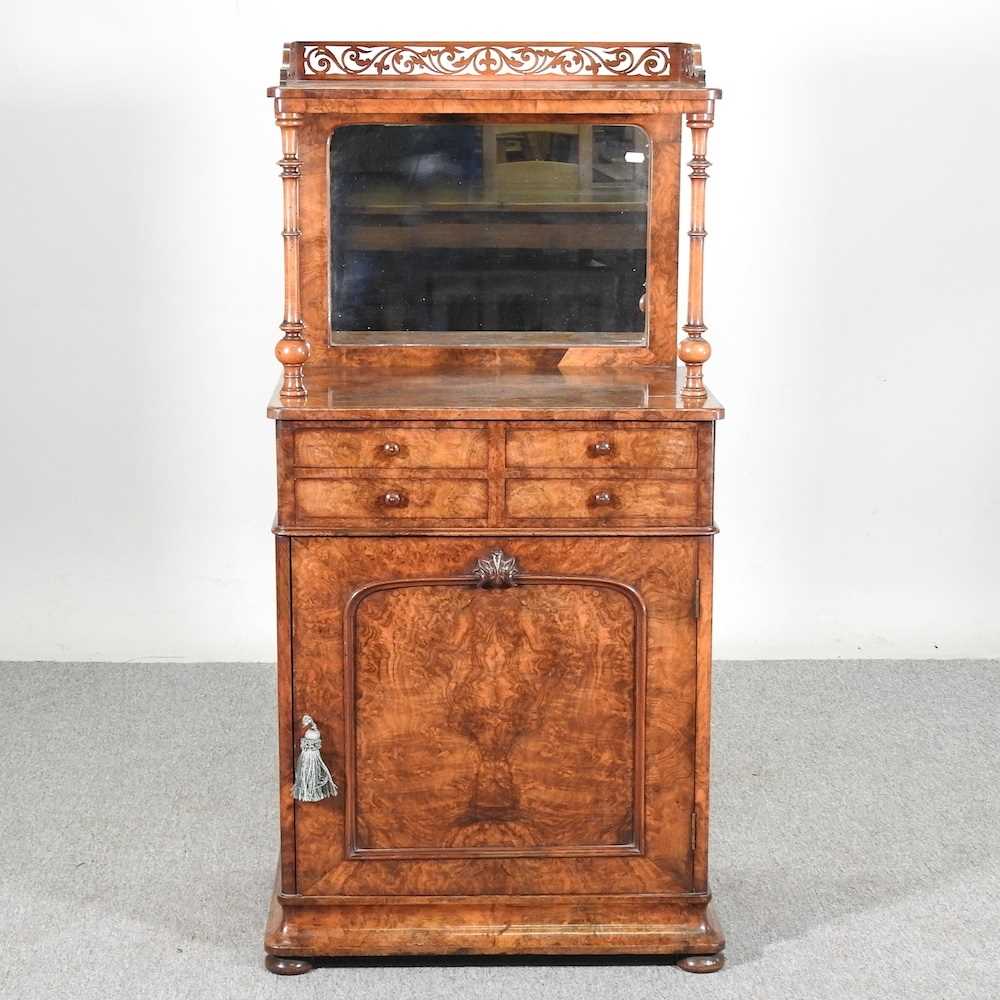 A good Victorian burr walnut mirror back music cabinet, with a fret carved gallery, above four short