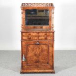 A good Victorian burr walnut mirror back music cabinet, with a fret carved gallery, above four short