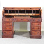 A large Victorian mahogany cylinder desk, the fitted interior with a sloping writing surface, on a