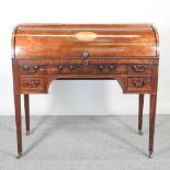 A George III mahogany cylinder desk, with satinwood inlay and ebony stringing, the fitted interior