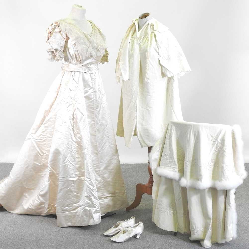 An Edwardian satin and lace wedding dress, with a lace petticoat, together with a shawl, with