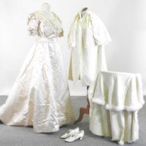 An Edwardian satin and lace wedding dress, with a lace petticoat, together with a shawl, with