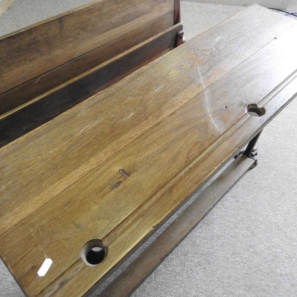 An early 20th century wooden school desk, on an iron base, stamped LEC 102w x 70d x 66h cm - Image 4 of 5