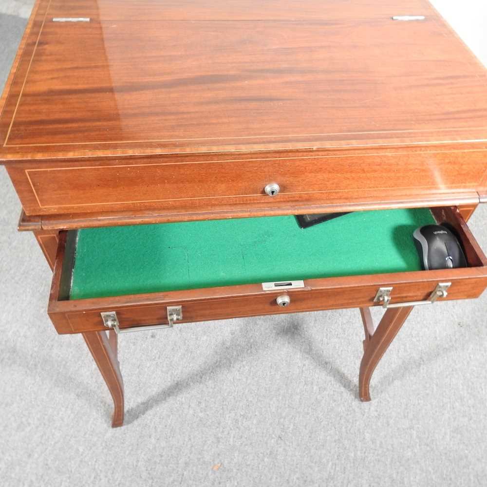 An early 20th century mahogany military style writing desk, with a dual hinged top, revealing a - Image 2 of 9