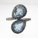 An 18 carat white gold and aquamarine cluster ring, of crossover design, set with two opposing heart