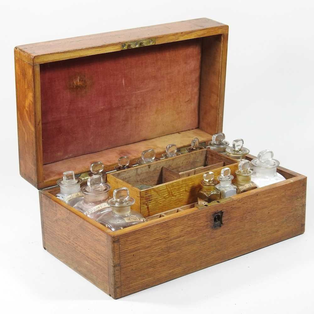 A 19th century oak cased apothecary box, the fitted interior containing labelled glass medicine