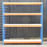 A metal shelving unit, with chipboard shelves