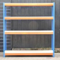 A metal shelving unit, with chipboard shelves