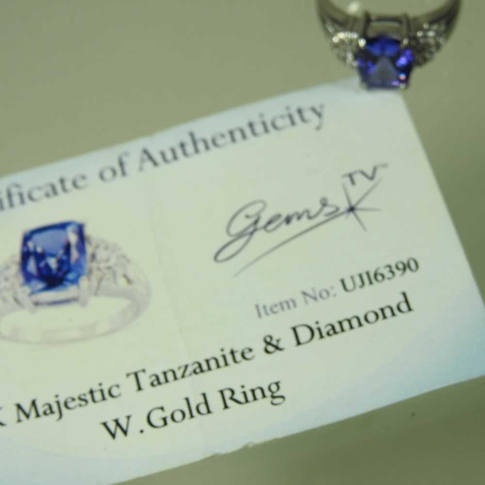 An 18 carat white gold, diamond and tanzanite dress ring, the central stone approximately three - Image 2 of 6