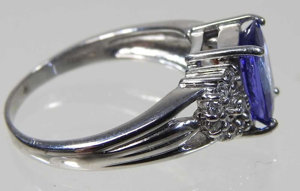 An 18 carat white gold, diamond and tanzanite dress ring, the central stone approximately three - Image 3 of 6