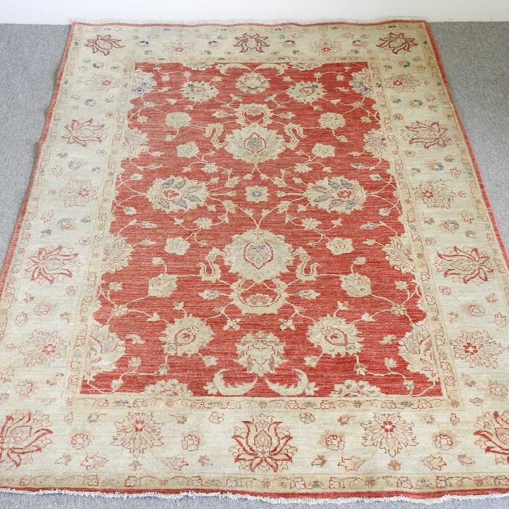 A kashan carpet, with floral designs, on a red ground, 240 x 172cm