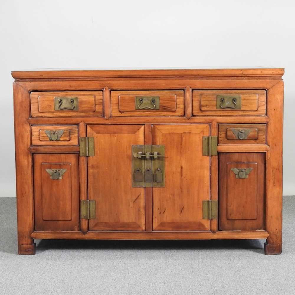 A modern Chinese hardwood sideboard, containing short drawers and cupboards 126w x 50d x 88h cm