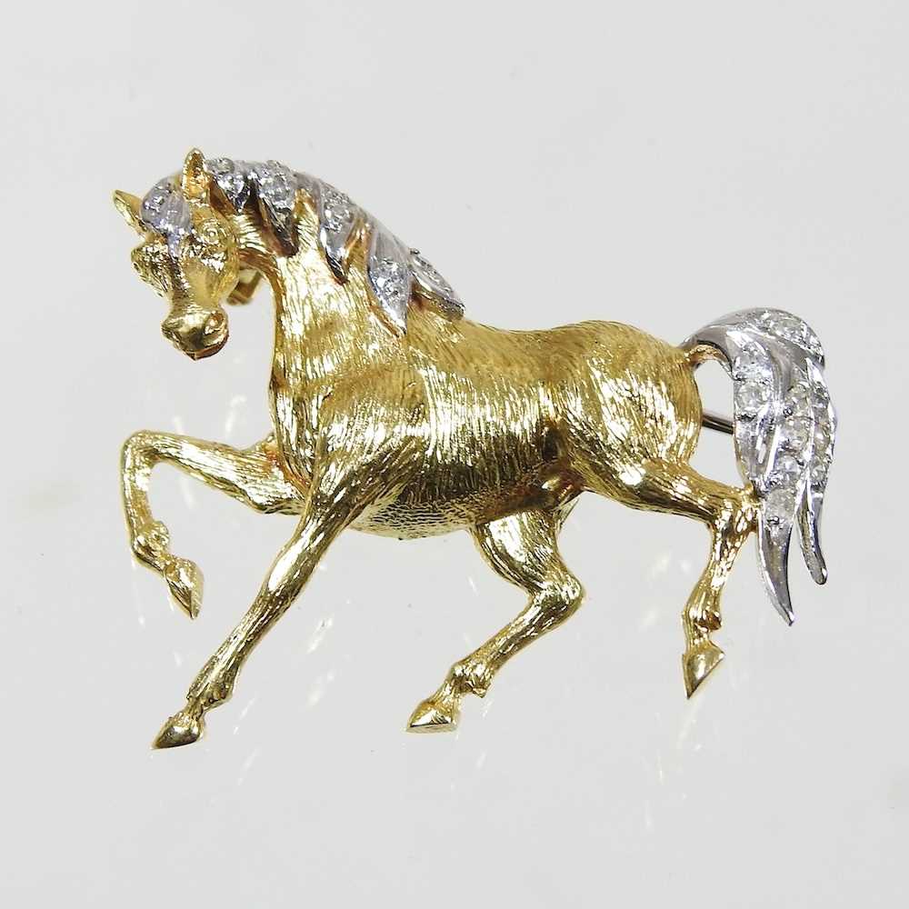 An 18 carat gold brooch, in the form of a horse, with a diamond set mane and tail, having a pin