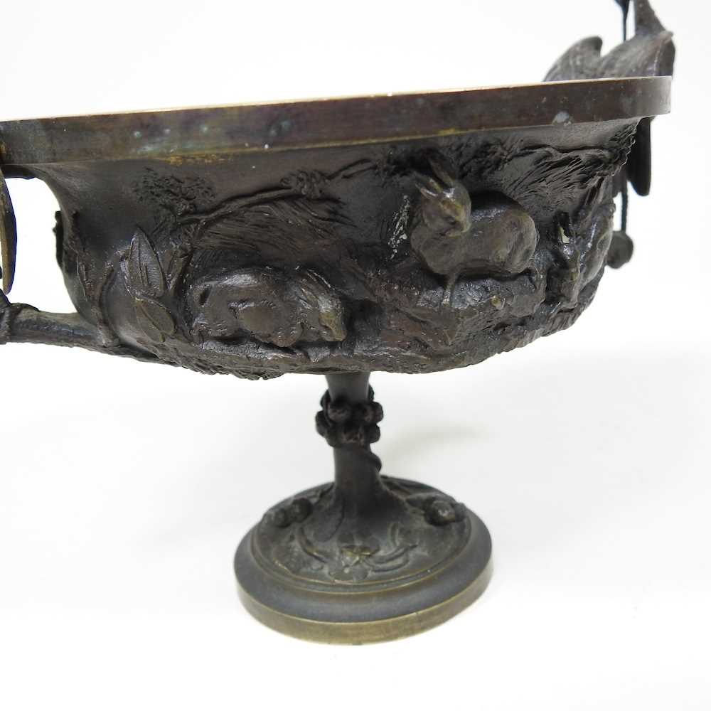 A 19th century cast bronze cup and cover, of pedestal form, decorated in relief with game, flanked - Image 7 of 12