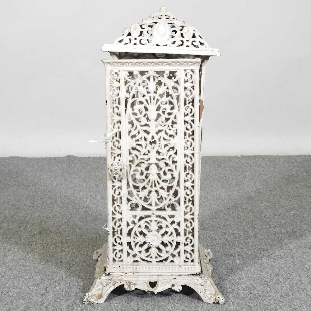 An early 20th century cream painted cast iron conservatory heater, 54cm high