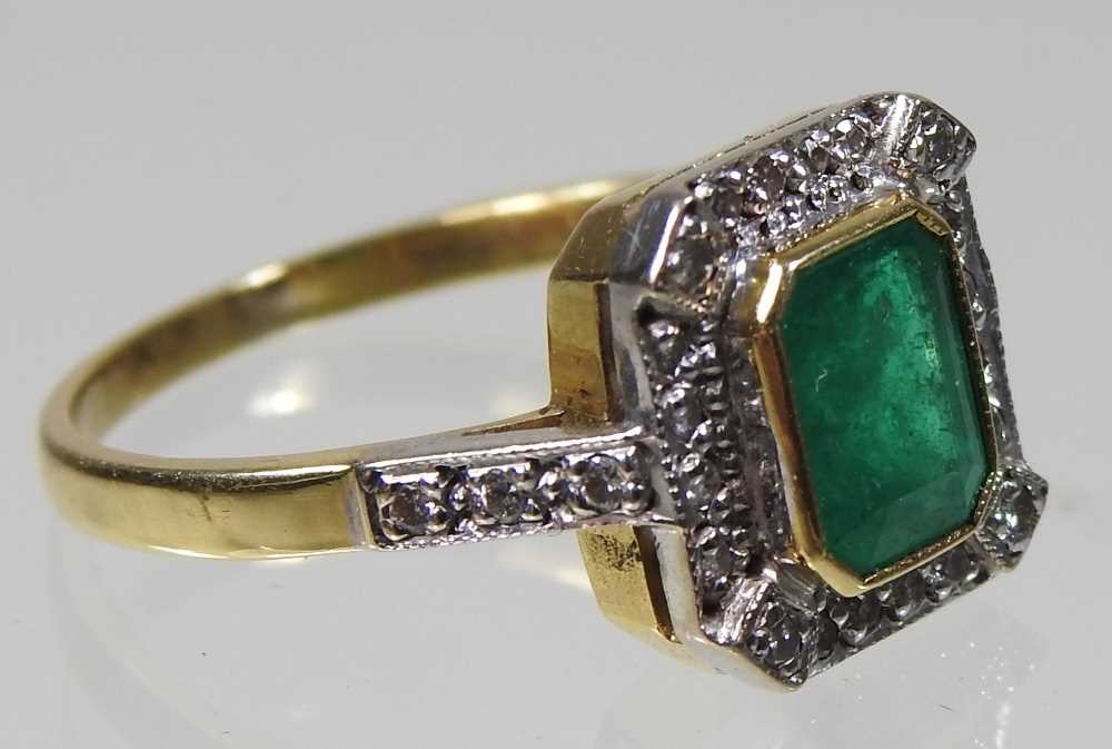 An unmarked emerald and diamond cluster ring, of Art Deco design, with a central baguette cut - Image 3 of 4