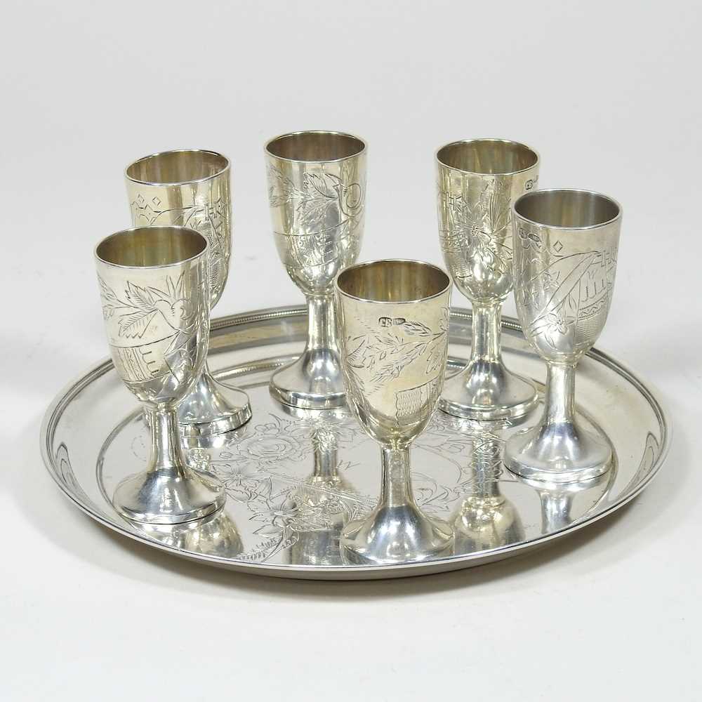 A Russian silver liqueur set, engraved with flowers, with six stem shot cups, 7cm high, on a
