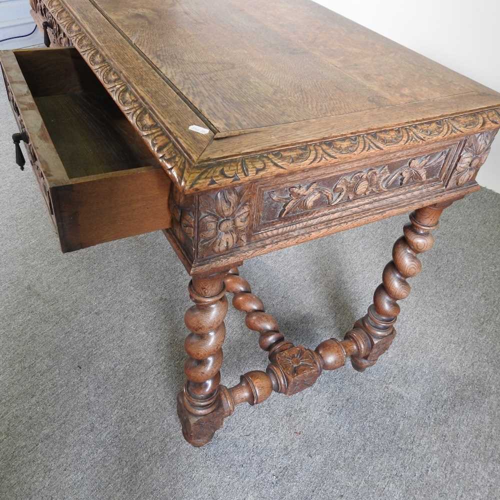 An early 20th century carved oak writing table, on spirally turned supports 120w x 60d x 75h cm - Image 4 of 5