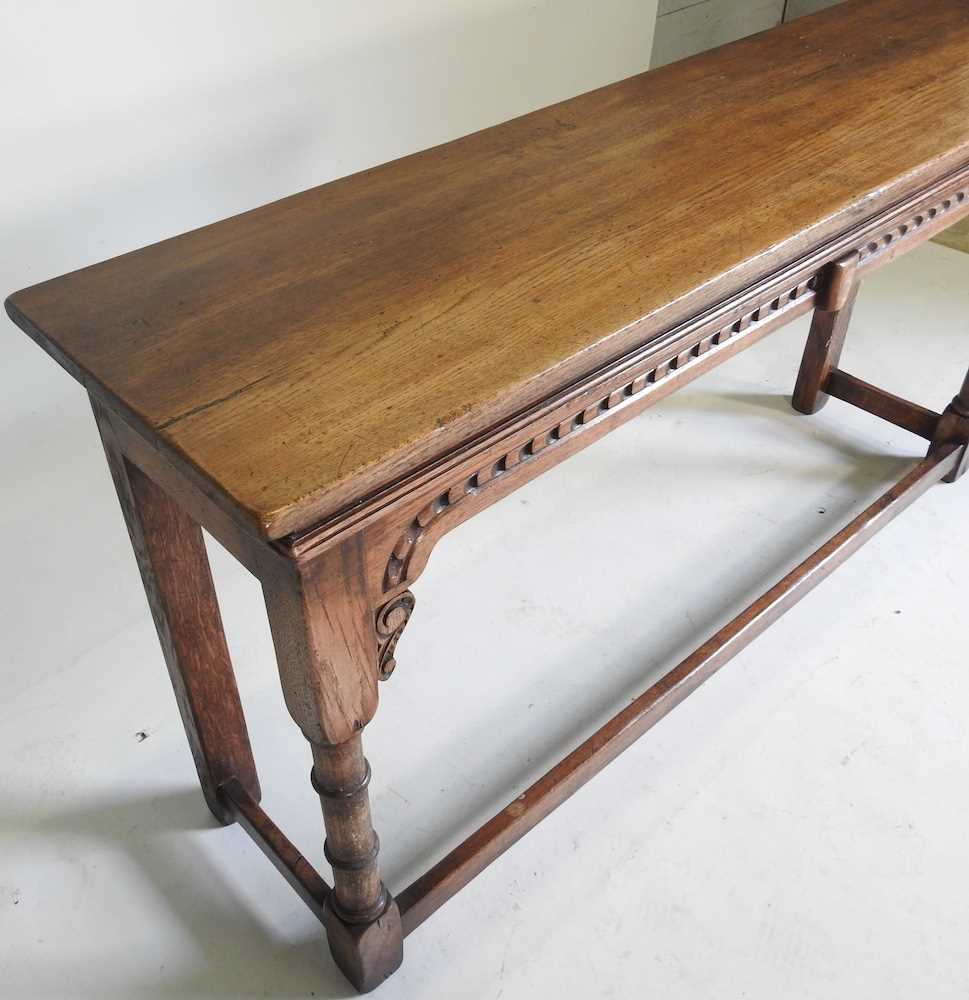 A carved oak console table, 20th century, on turned legs, united by a stretcher 137w x 36d x 71h cm - Image 3 of 3