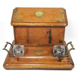 An early 20th century brass mounted oak desk stand, 31cm wide