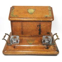 An early 20th century brass mounted oak desk stand, 31cm wide