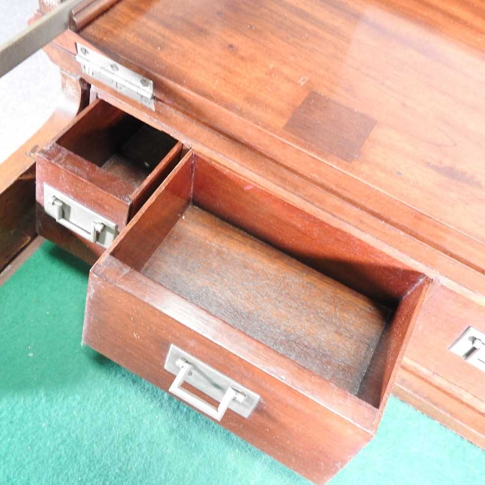 An early 20th century mahogany military style writing desk, with a dual hinged top, revealing a - Image 5 of 9