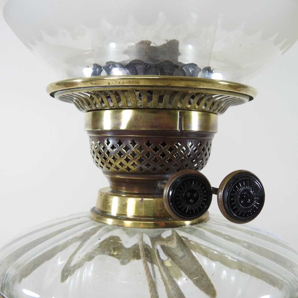 An ornate 19th century brass oil lamp, with an etched glass shade, clear glass font and scrolled - Image 3 of 6