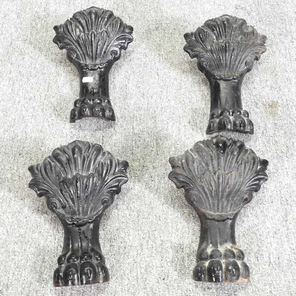 A set of four black painted cast iron bath legs, each in the form of a lion's paw, with shell