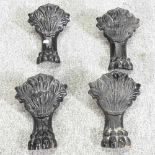 A set of four black painted cast iron bath legs, each in the form of a lion's paw, with shell