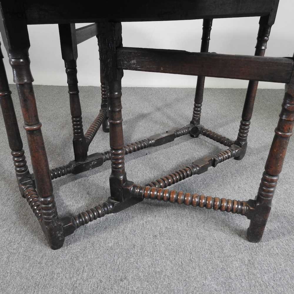 An 18th century oak gateleg table, with a hinged oval top, on bobbin turned legs 108w x 44d x 72h cm - Image 2 of 5