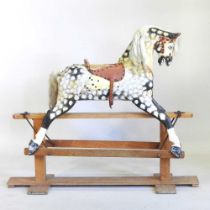 An early to mid 20th century painted wooden dappled grey rocking horse, on a wooden trestle base