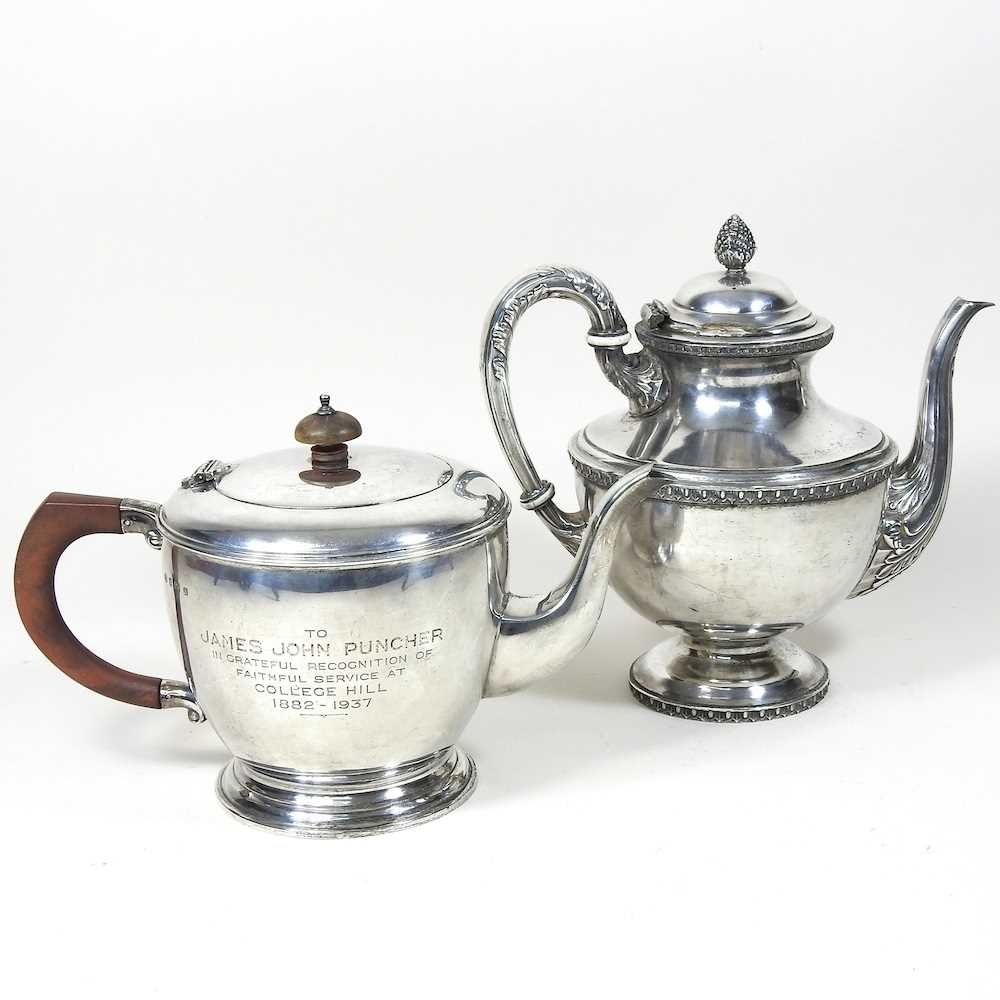An Art Deco silver teapot, of circular shape, with a wooden handle and finial, with presentation