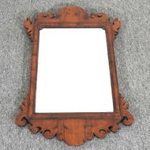An early 20th century yew wood fret carved wall mirror, of small proportions 37w x 64h cm